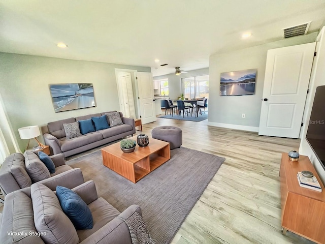 living room with hardwood / wood-style flooring and ceiling fan