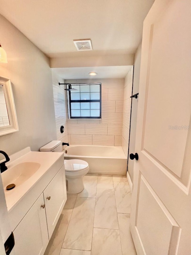 full bathroom featuring vanity, toilet, and tiled shower / bath