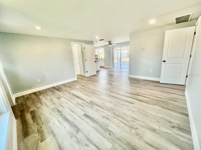 unfurnished room with ceiling fan and light wood-type flooring