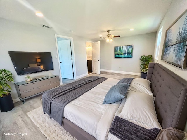 bedroom featuring ceiling fan, light wood-type flooring, and connected bathroom