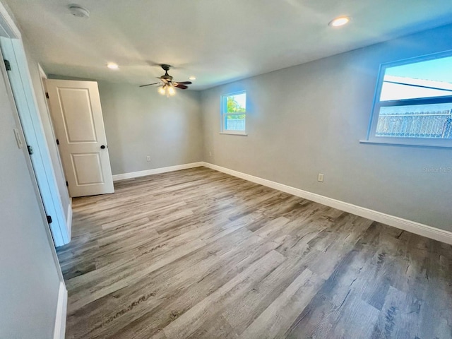 empty room featuring light wood-type flooring and ceiling fan