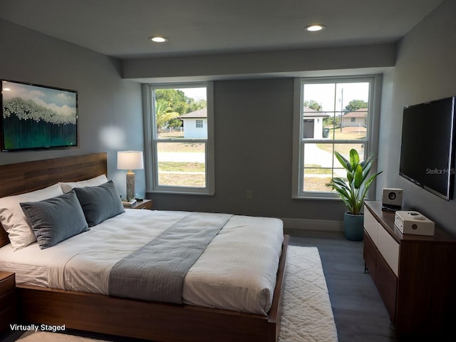 bedroom featuring wood-type flooring and multiple windows