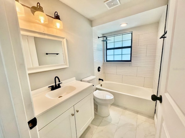 full bathroom with vanity, tiled shower / bath combo, and toilet