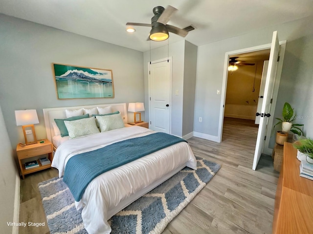 bedroom featuring ceiling fan and light hardwood / wood-style flooring