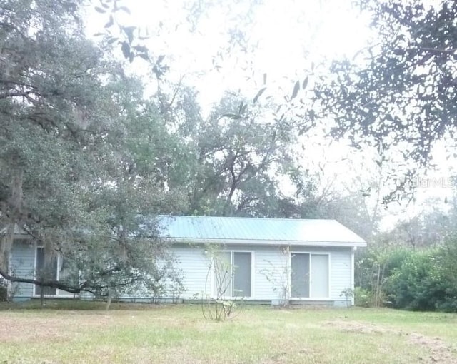 view of outbuilding featuring a yard