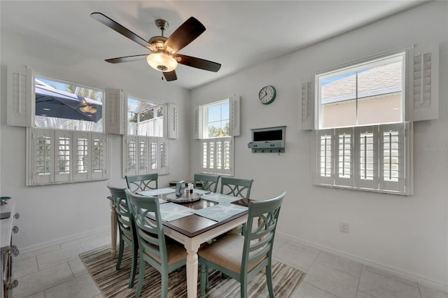 tiled dining room with ceiling fan