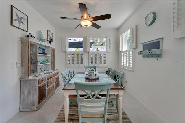 tiled dining area with ceiling fan