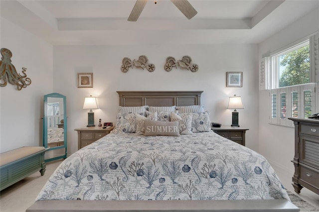 bedroom featuring ceiling fan and a raised ceiling