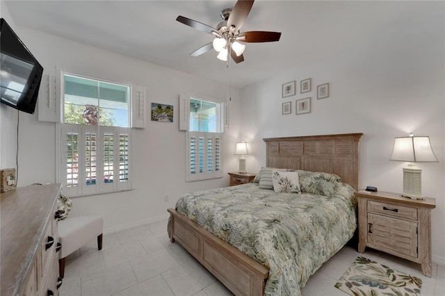 bedroom with ceiling fan and light tile patterned floors