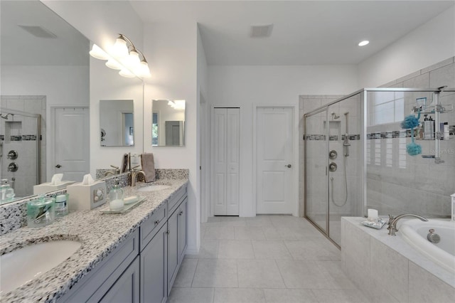 bathroom featuring separate shower and tub, tile patterned floors, and vanity