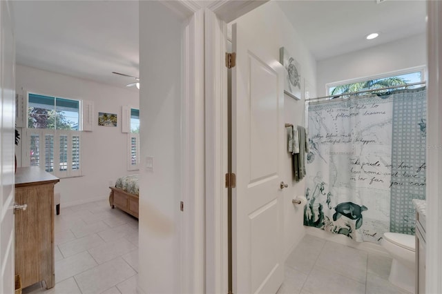 bathroom featuring a healthy amount of sunlight, tile patterned flooring, curtained shower, and toilet