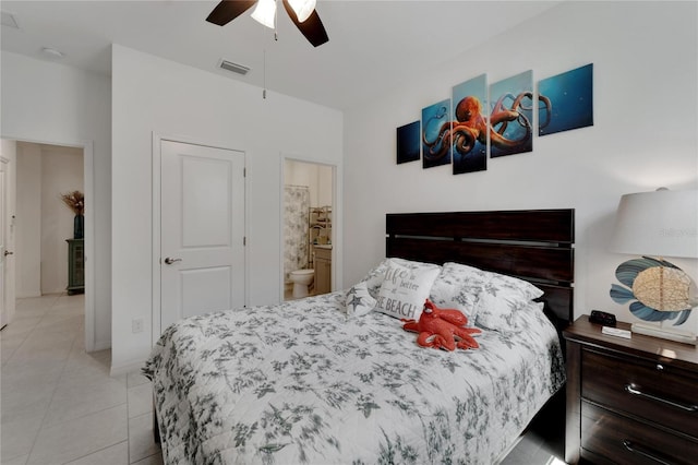 bedroom with ceiling fan, ensuite bath, and light tile patterned floors