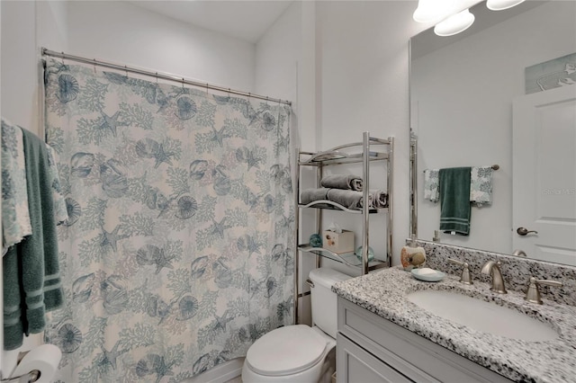 bathroom with a shower with shower curtain, vanity, and toilet