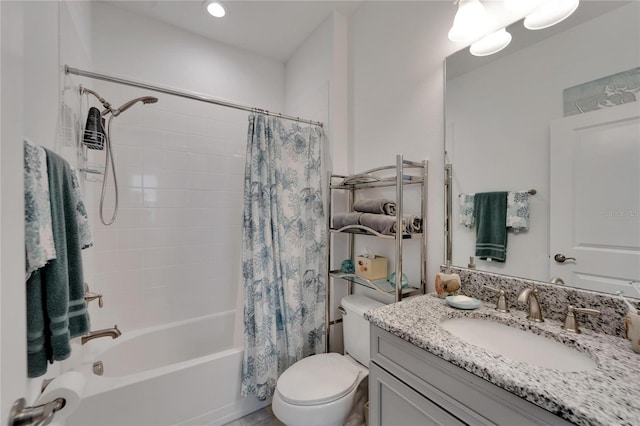 full bathroom featuring shower / bath combination with curtain, vanity, and toilet