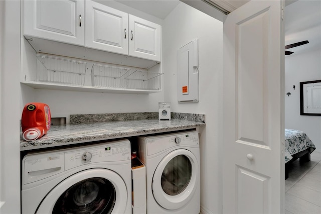 washroom featuring separate washer and dryer, cabinets, ceiling fan, electric panel, and light tile patterned flooring