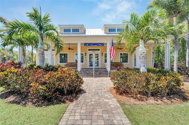 view of front of home with a porch, ceiling fan, and french doors