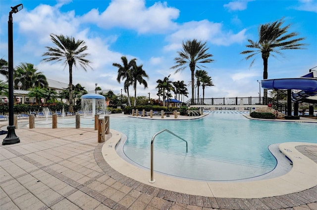 view of swimming pool with pool water feature and a patio area