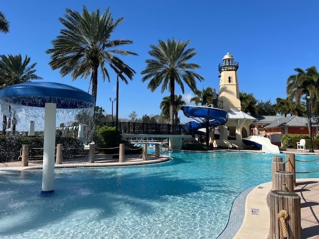 view of swimming pool with a water slide