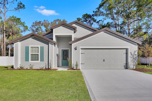 view of front of house with a garage and a front lawn