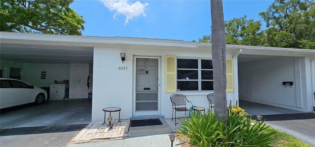 doorway to property with a carport