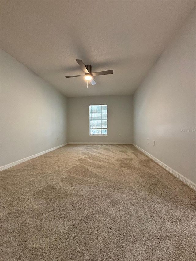 carpeted empty room featuring a textured ceiling and ceiling fan