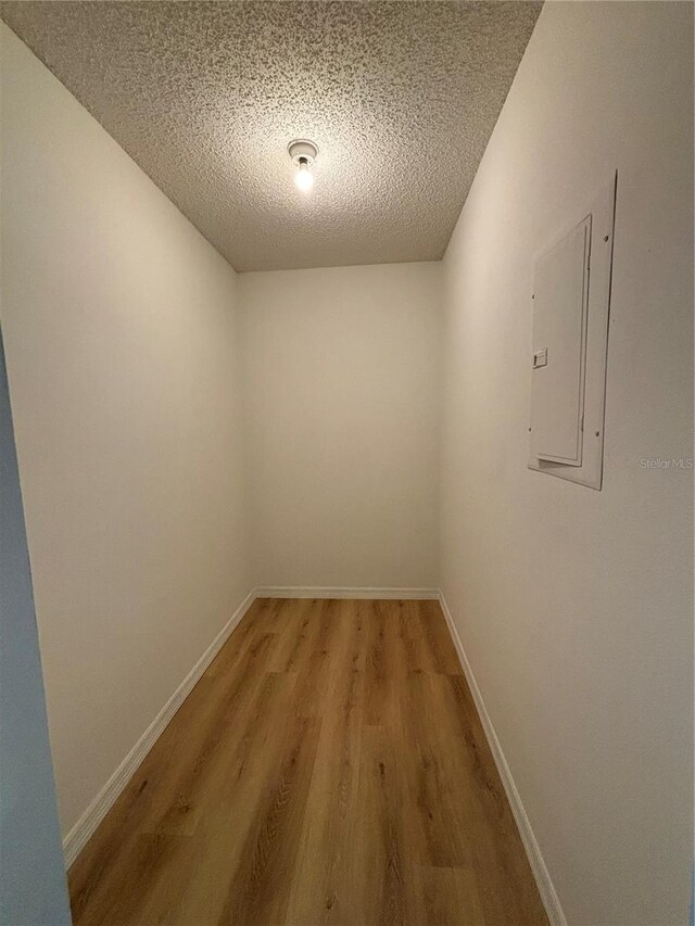 spare room with hardwood / wood-style flooring and a textured ceiling