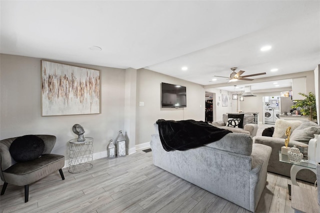 living room featuring light wood-type flooring and ceiling fan