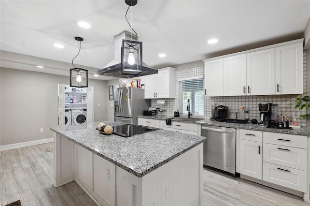 kitchen featuring pendant lighting, a center island, white cabinets, appliances with stainless steel finishes, and sink