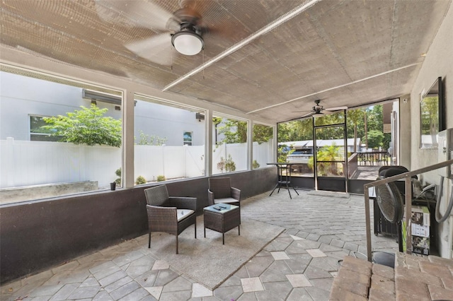 sunroom / solarium featuring ceiling fan