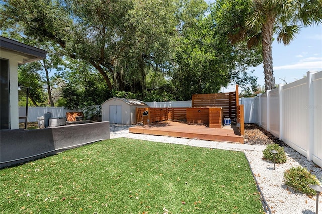 view of yard featuring a storage shed and a wooden deck