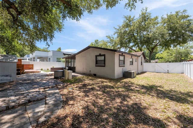 rear view of property featuring a patio and central AC unit