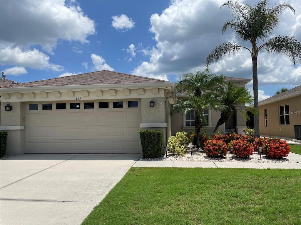 view of front facade with a front lawn and a garage