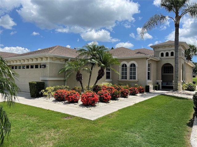 view of front of property with a front yard and a garage