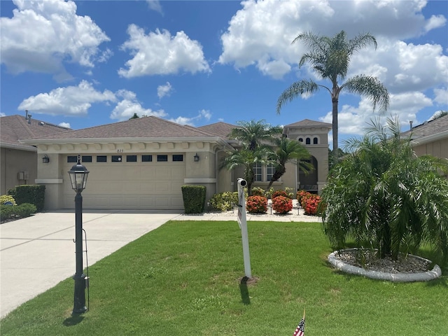 view of front facade featuring a garage and a front lawn