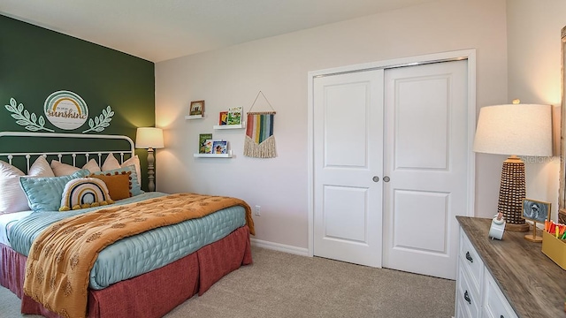 bedroom with light carpet and a closet