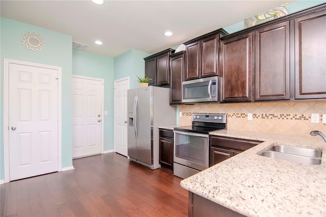 kitchen featuring sink, dark hardwood / wood-style flooring, dark brown cabinetry, and stainless steel appliances