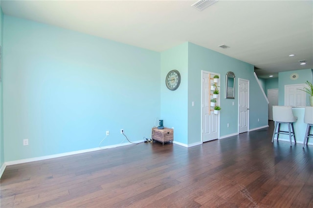 unfurnished living room featuring dark hardwood / wood-style floors