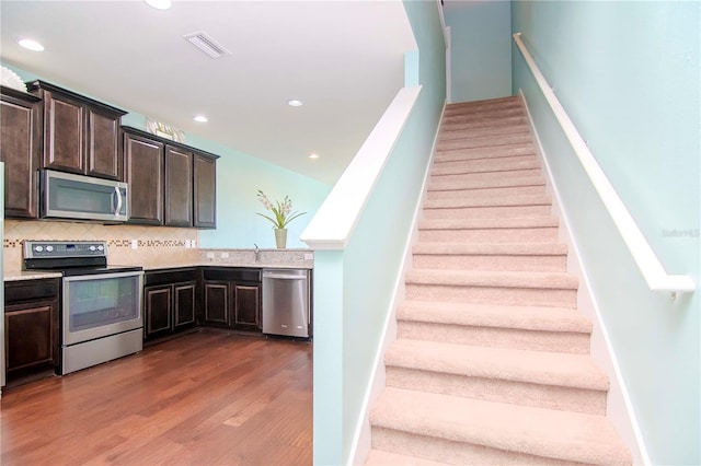 stairs with hardwood / wood-style floors