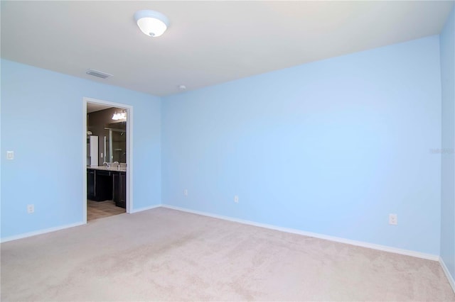 unfurnished room with light carpet