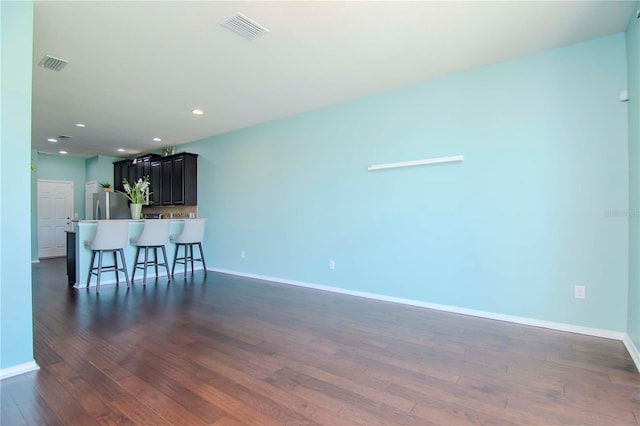 unfurnished living room featuring dark hardwood / wood-style floors