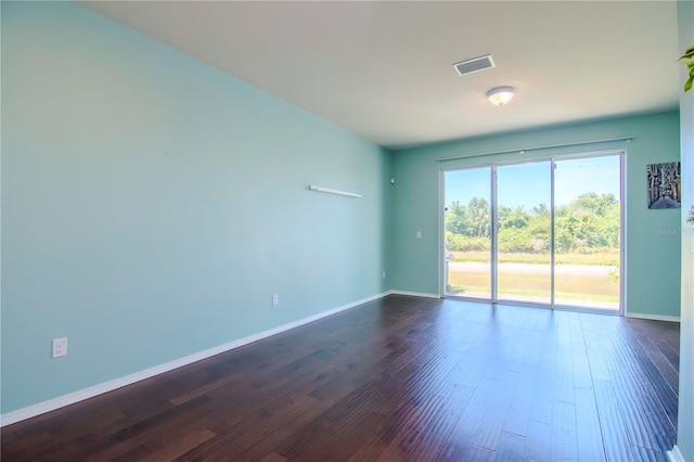 spare room with dark hardwood / wood-style flooring