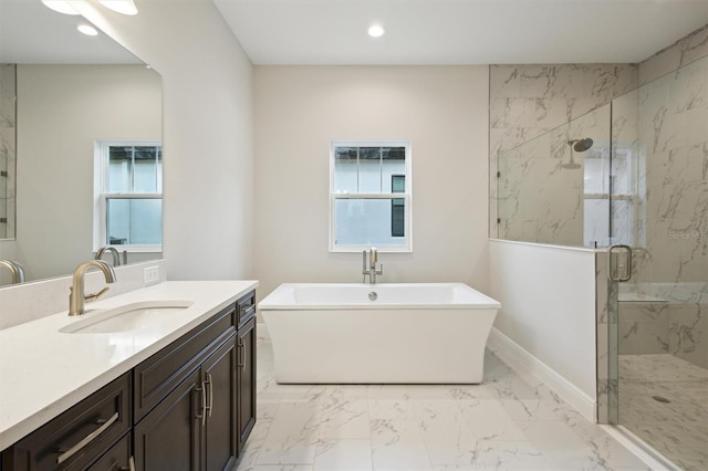 bathroom featuring plenty of natural light, shower with separate bathtub, and vanity