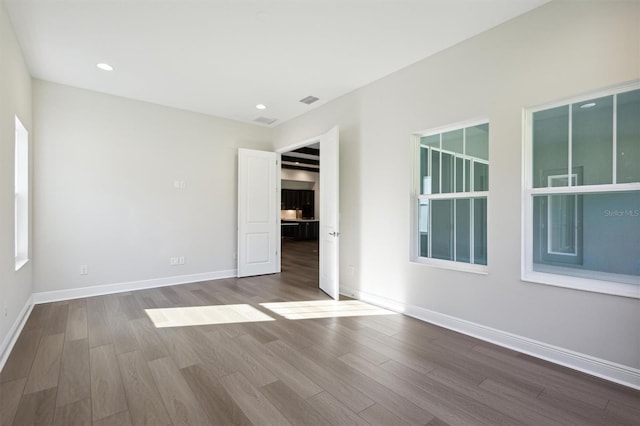 unfurnished room featuring wood-type flooring