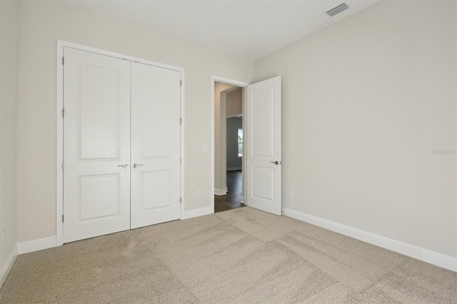 unfurnished bedroom with carpet floors and a closet