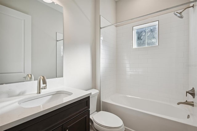 full bathroom with toilet, vanity, and tiled shower / bath