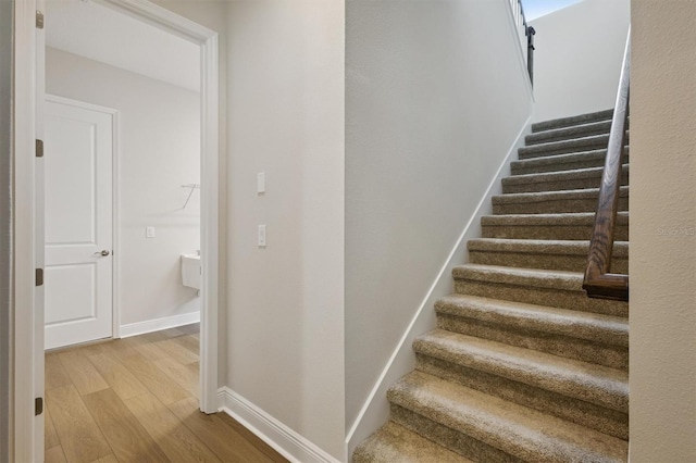 staircase with hardwood / wood-style flooring