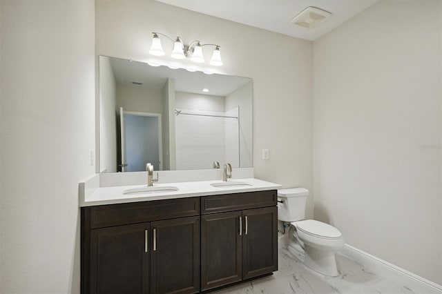 bathroom featuring toilet, a shower, and vanity