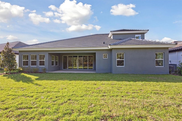 back of house featuring a yard and central AC unit