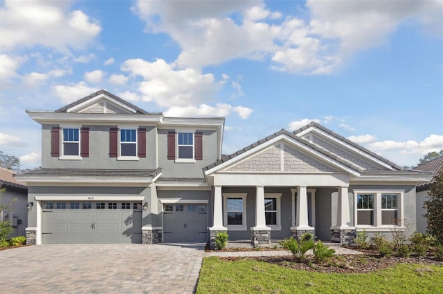 craftsman house featuring a porch and a garage