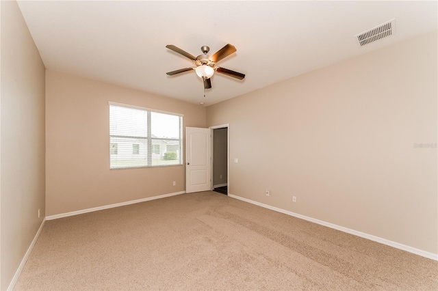 unfurnished room with carpet and ceiling fan